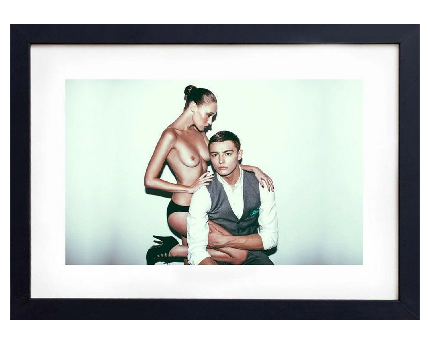 Framed artwork of two people embracing with a plain background