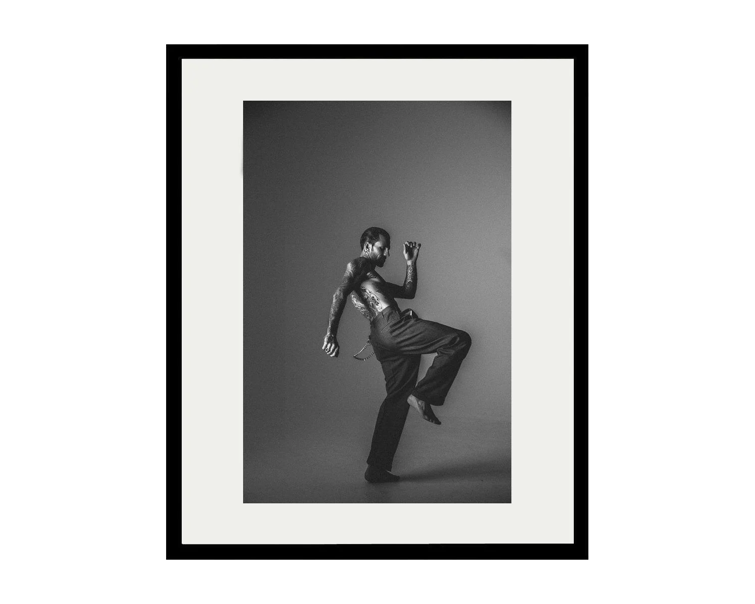 Framed black and white photograph of a dancer posing against a dark background