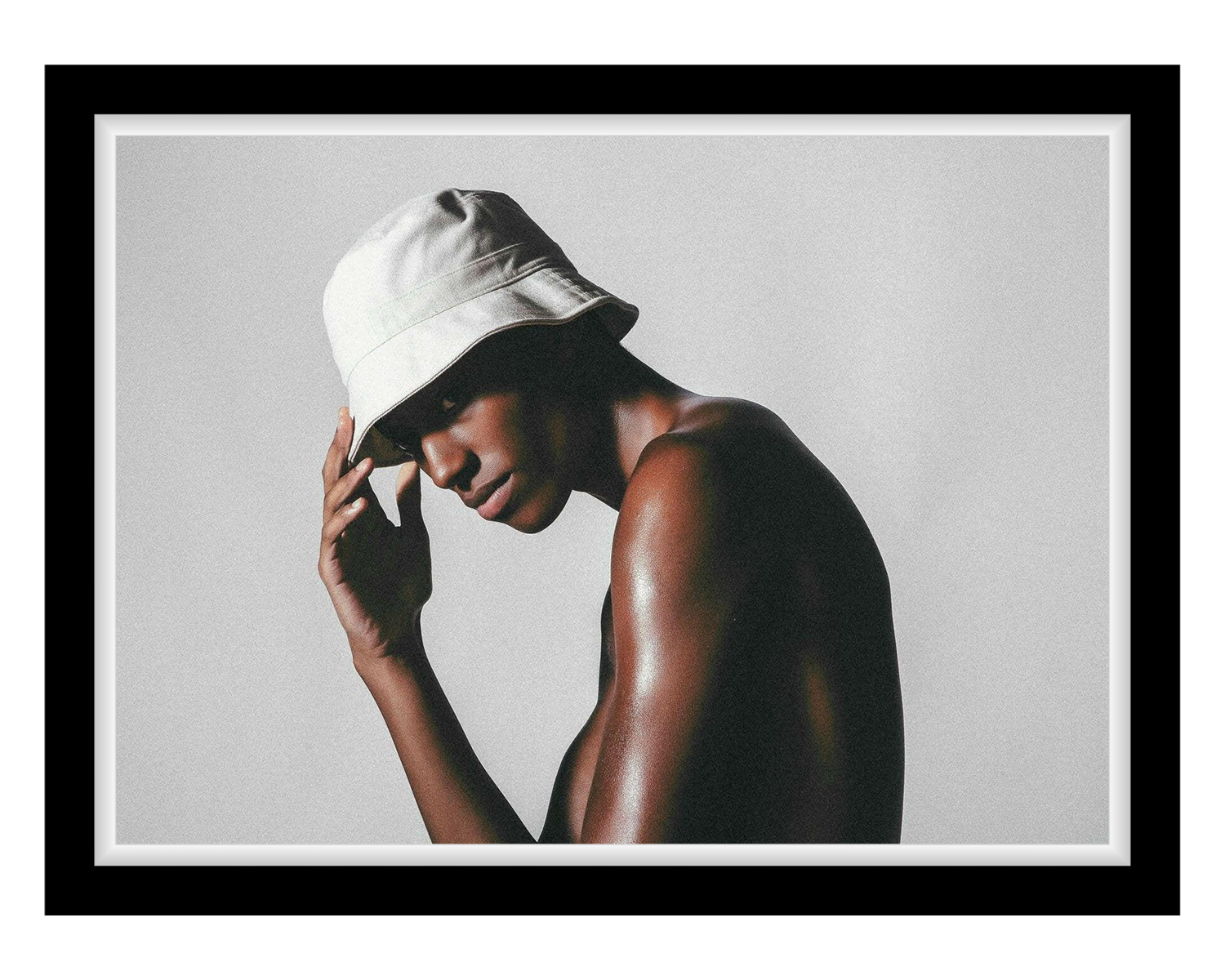 Man wearing a white bucket hat against a plain background