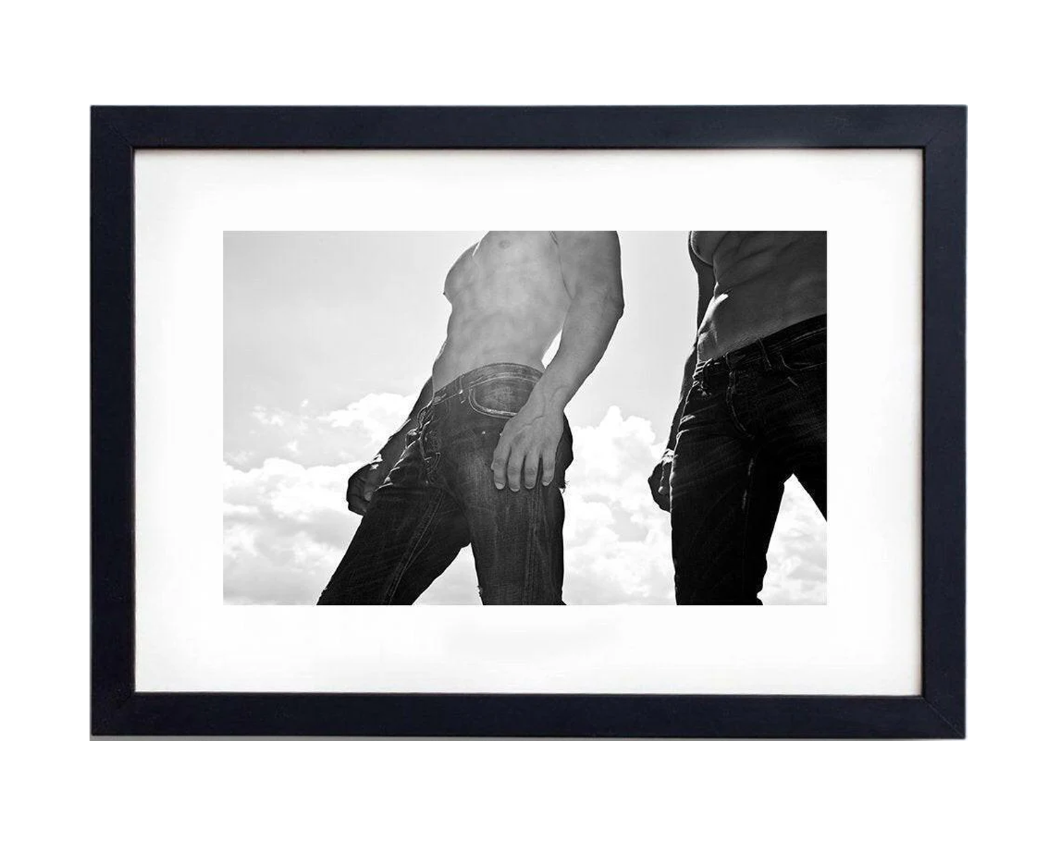 Framed black and white photo of two shirtless men standing together, displaying friendly body language in a casual setting.