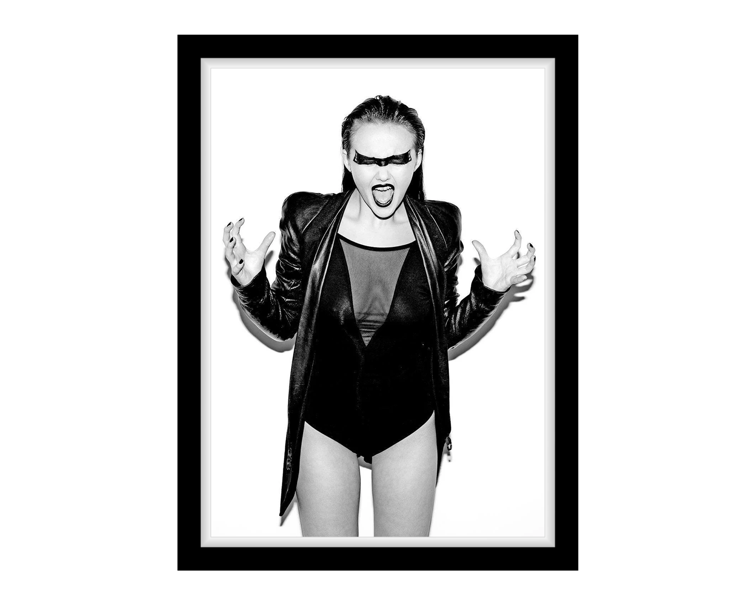 Framed black and white portrait of a girl wearing a leather jacket and bodysuit.