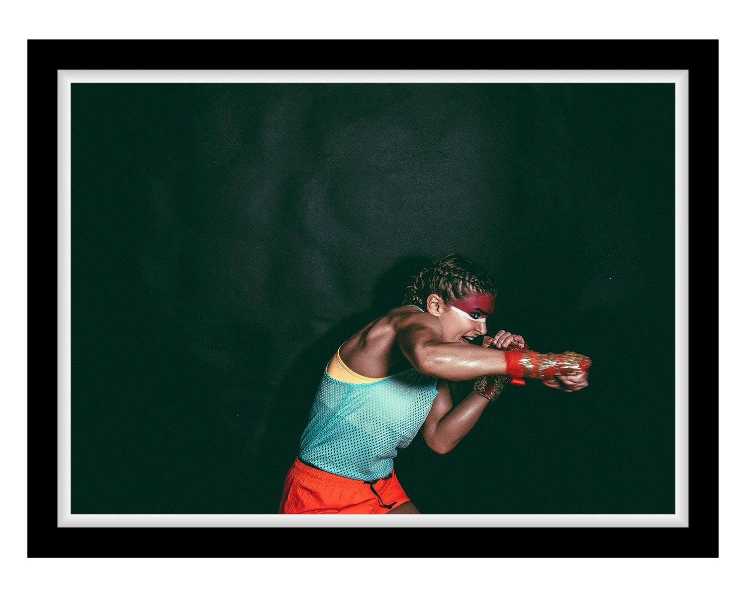Girl in athletic wear with red gloves and headband against a dark background