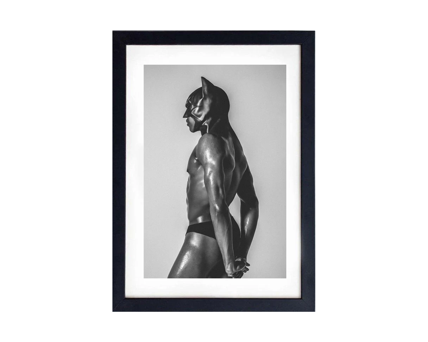 Framed black and white photograph of a muscular figure in a dynamic pose.