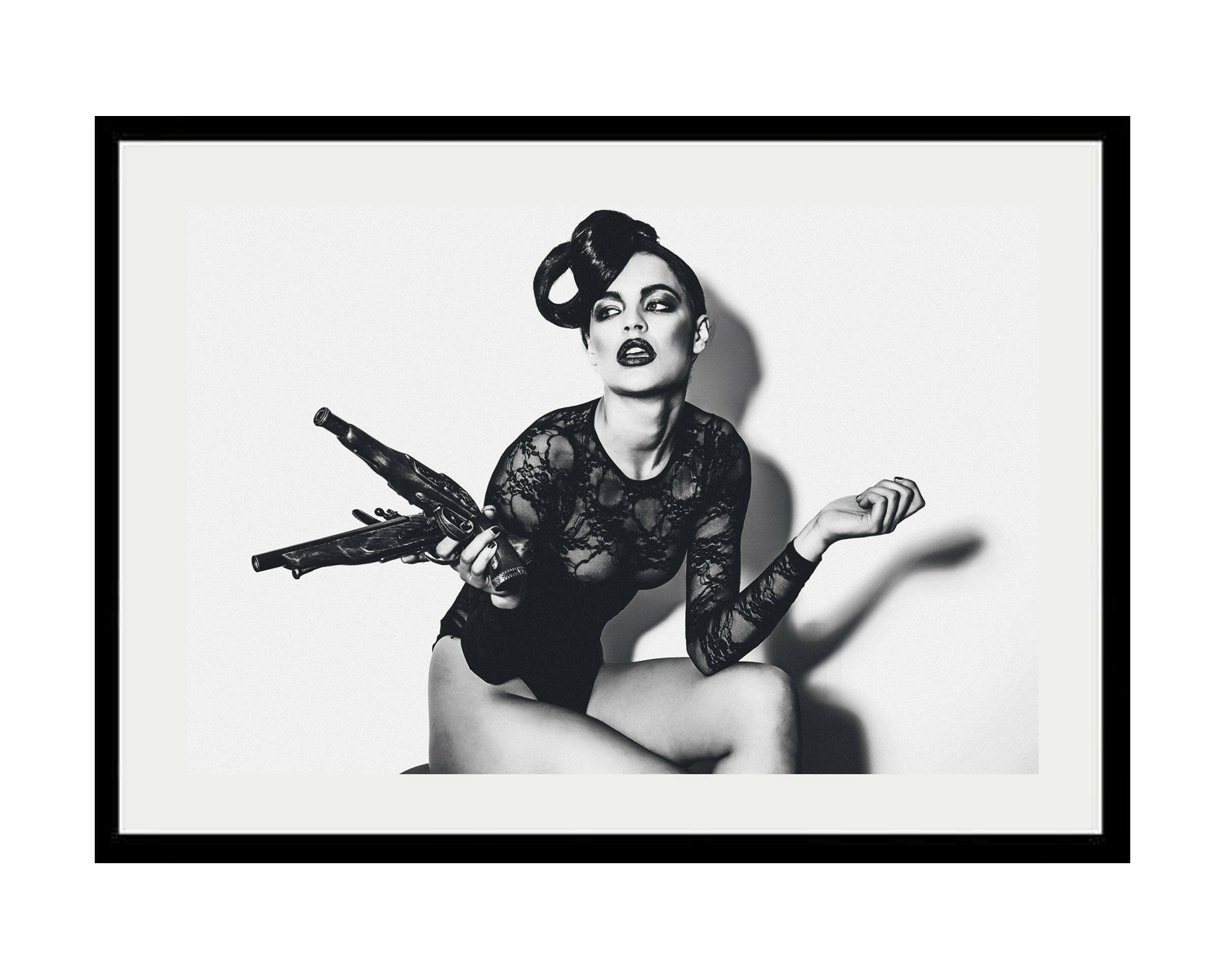 Framed black and white artwork of a woman holding a gun on a white background