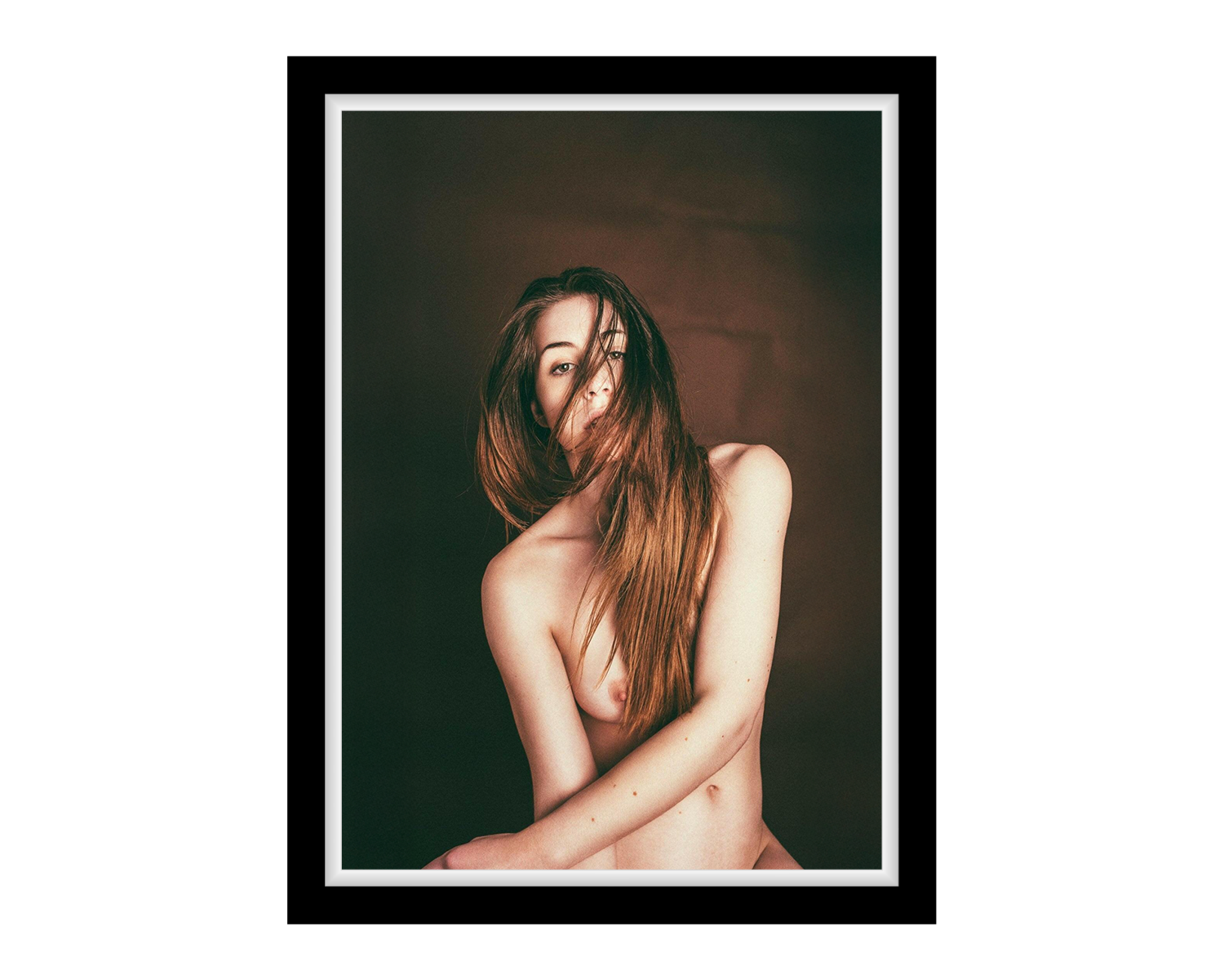 Framed portrait of a nude girl with long hair against a dark background