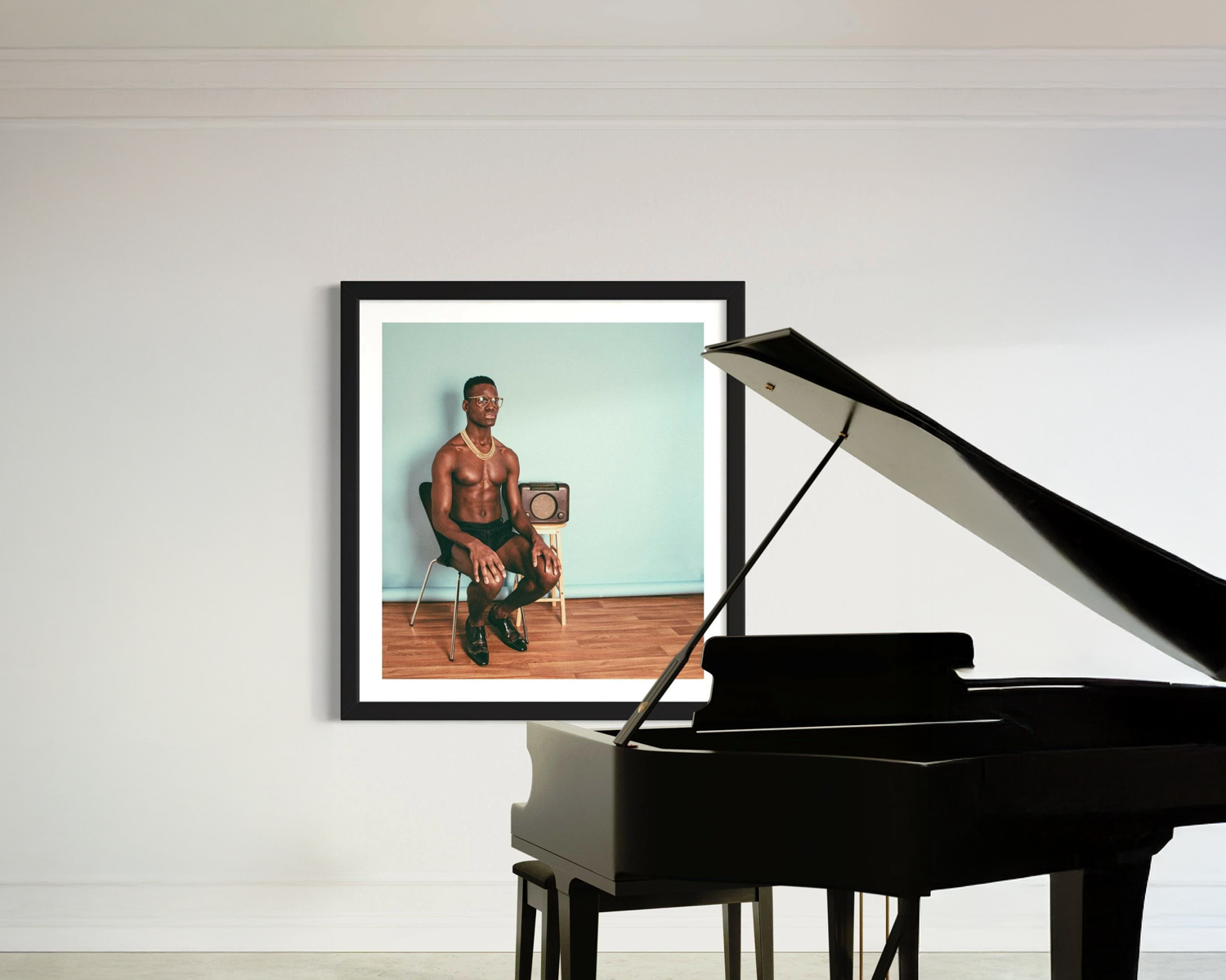 Framed portrait of a man sitting on a chair next to a grand piano